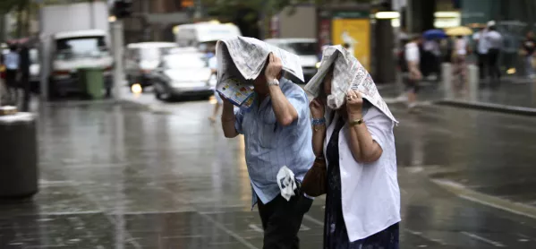 People Using Paper To Shield Themselves From The Rain