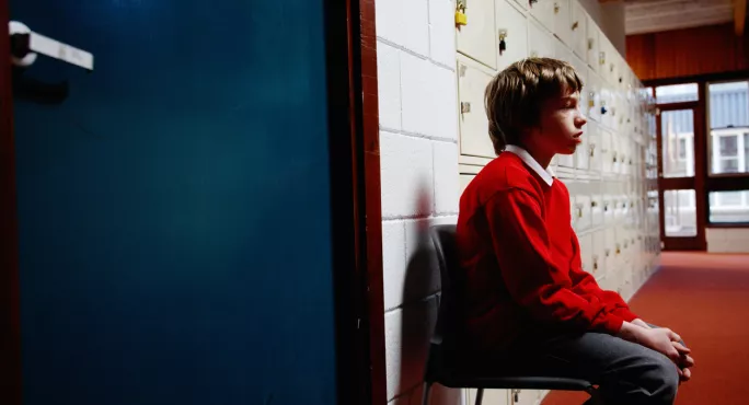 Child Sitting In Corridor