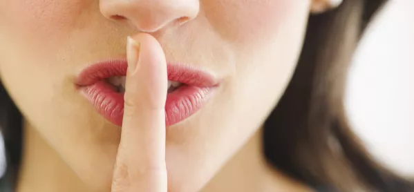 Woman Holding Finger To Her Lips