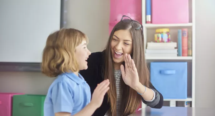 Pupil & Teacher High-five One Another