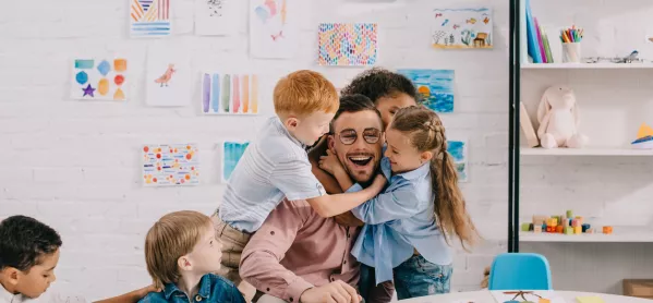 Primary-school Pupils Hugging Teacher