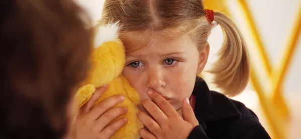 Young Child Crying & Holding A Soft Toy