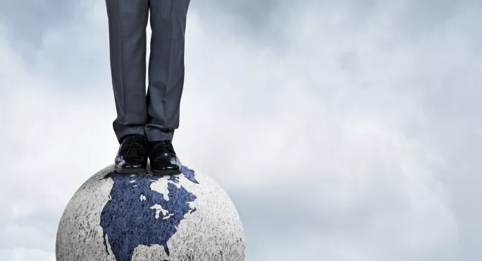 Man Standing On A Globe, Among The Clouds