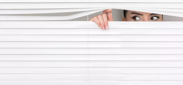 Woman Peering Out From Behind Blinds