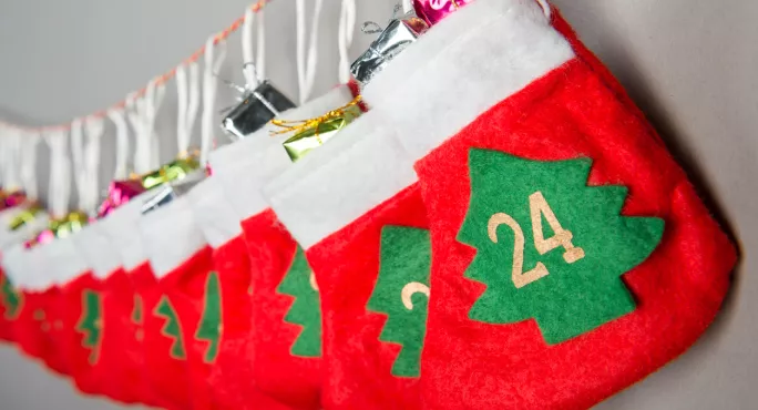 Advent Calendar, Made Up Of A Series Of Present-filled Stockings, Strung Up In A Row