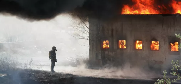 Man, Standing Next To Burning Building