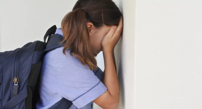 Schoolgirl, Leaning Against A Wall & Crying