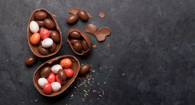 An Easter Egg, Broken Open To Reveal Mini-chocolates Inside