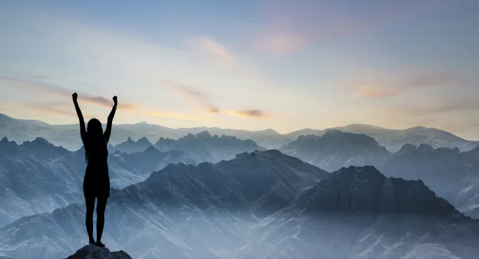 Woman On Top Of A Mountain