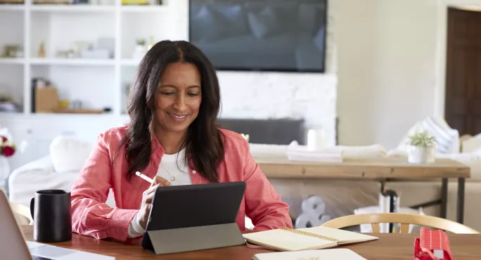 Woman Working From Home At A Laptop