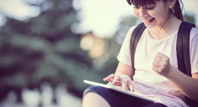 Child Reading For Pleasure On A Tablet