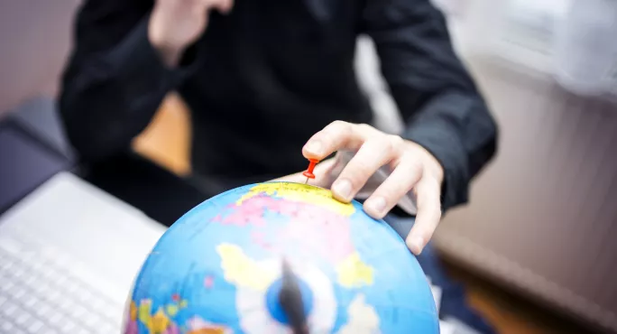 Teacher Looking At Globe