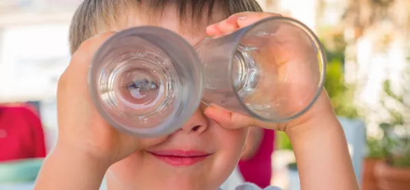 Young Boy Uses Two Drinks Glasses As Binoculars