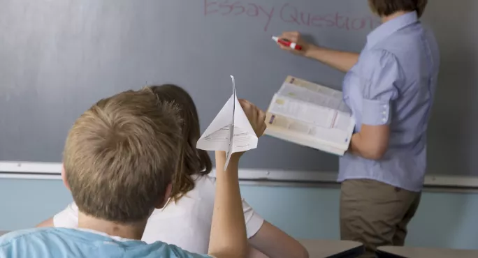 Pupil Aims Paper Aeroplane At Teacher