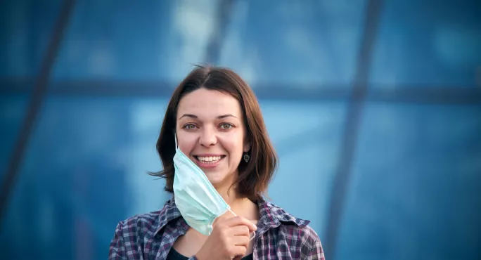 Woman Takes Off Her Face Mask