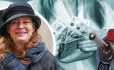 Gillian Keegan in hat against "on" switch