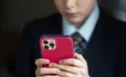 child on phone with red case