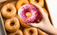 Hand picking fancy doughnut
