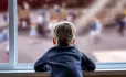 Child looking out of window at playground