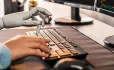 Human and robot hands using keyboard