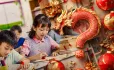 Chinese school children with dragon as question mark