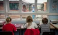 Children in classroom with broken window