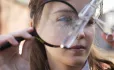 Girl looking at something in a magnifying glass - the subject is blurry