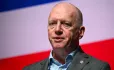 Matt Wrack in front on red, white and blue background