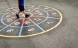 Pupil walking around numbers in playground