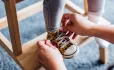 Mother tying child's shoes School Ready