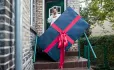 high expectations, behaviour, woman receiving huge parcel