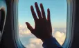 Hand inside plane window
