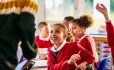 Child excited talking to teacher