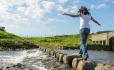 Girl walking on stepping stones