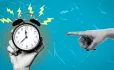 Hand pointing at alarm clock