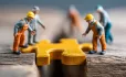Model figures fixing bridge with jigsaw piece