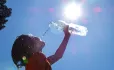 Student drinking water on hot sunny day