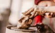 Hand sculpturing a clay figure