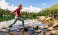 Woman stepping across a stream