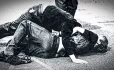 Two boys fighting on pavement