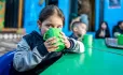 Child drinking at table