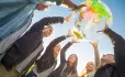 Students holding up globe