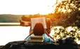 boy reading by lake