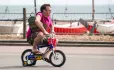 Man on child's bike