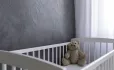 Empty Cot, With Teddy Bear In Corner