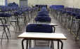 Pupils Take Exam, While Invigilator Paces Between Desks