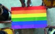 A Group Of Eyfs Students Stand Around A Colourful Gay Pride Poster