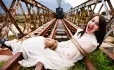 Woman Tied To Rail Tracks, While Steam Train Approaches In The Distance